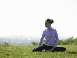 woman in field doing yoga